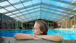 woman in pool with retractable enclosure